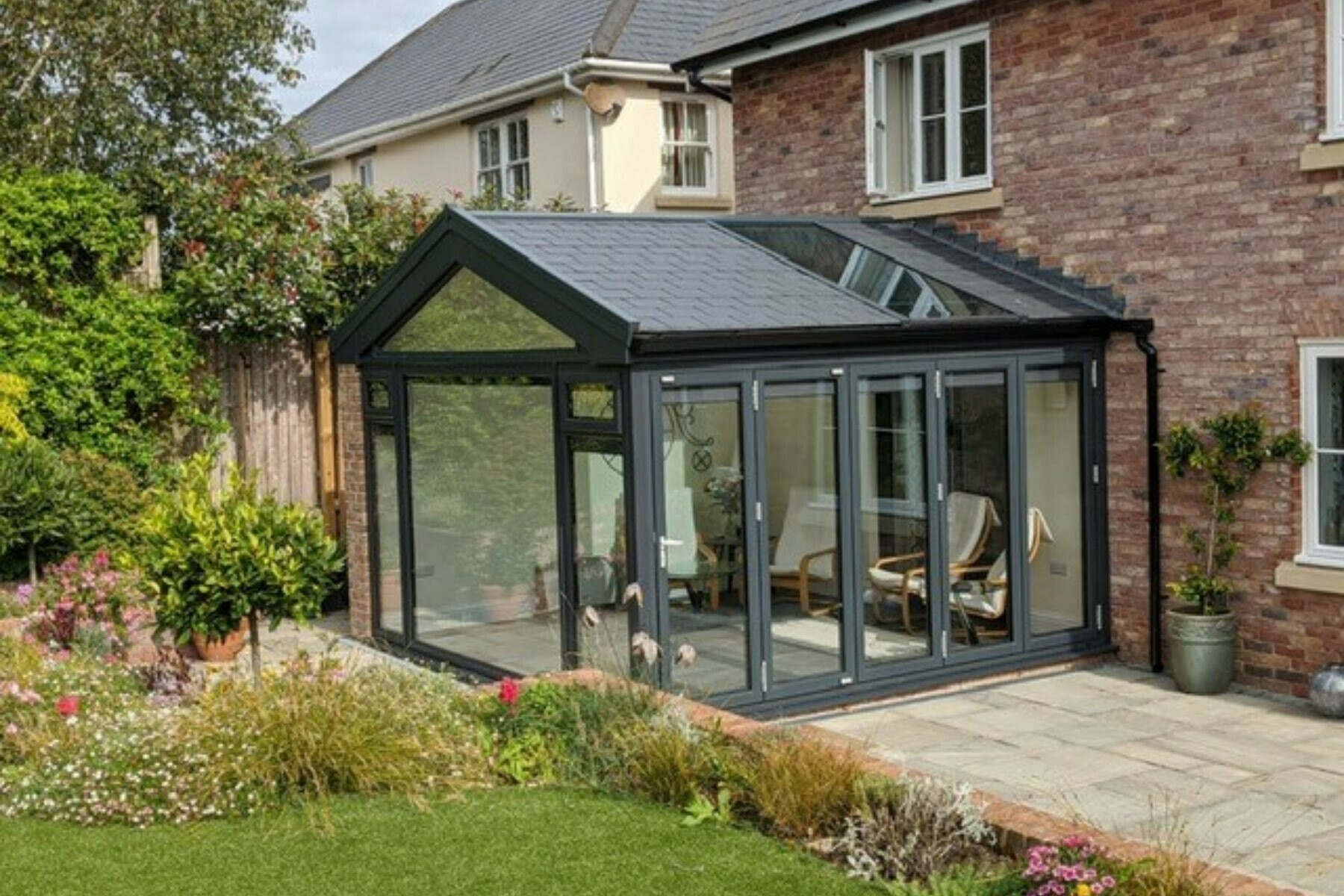 Aluminium conservatory with solid warm roof on a British home